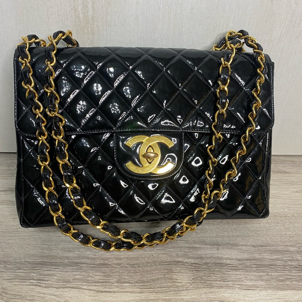 Used vintage jumbo classic black patent 24k gold hardware.